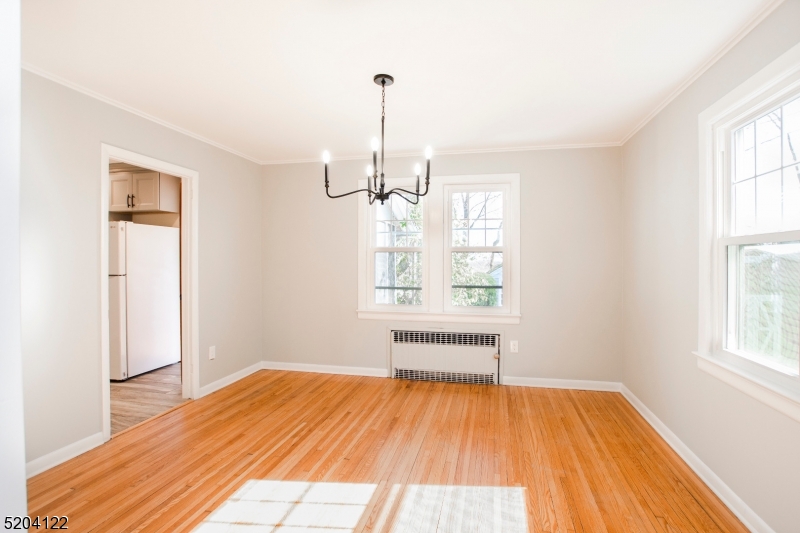 13 Clark Street Summit, NJ 07901 - Photo 6 of 24 a view of empty room with wooden floor and fan