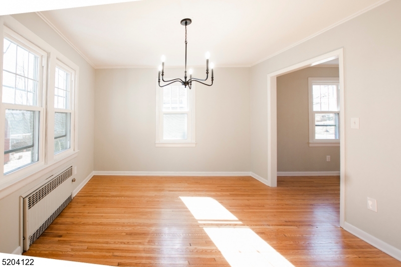 13 Clark Street Summit, NJ 07901 - Photo 7 of 24 a view of an empty room with a window and wooden floor