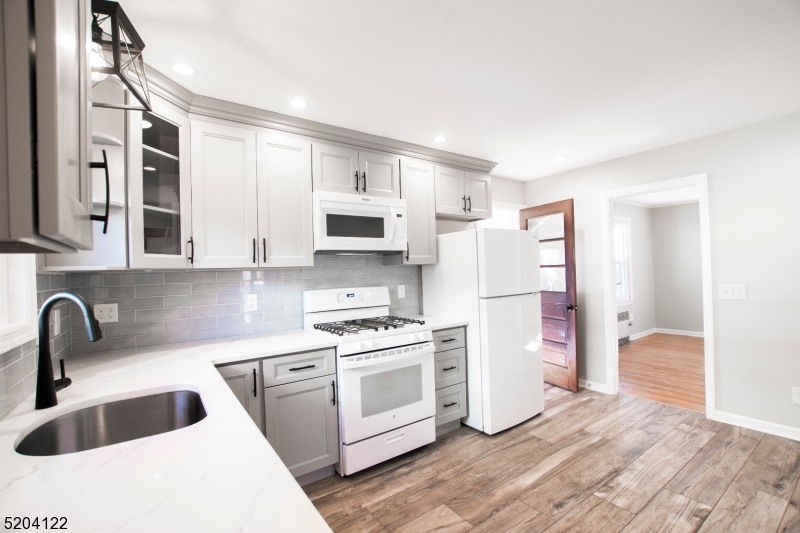 13 Clark Street Summit, NJ 07901 - Photo 8 of 24 a kitchen with white cabinets and white appliances