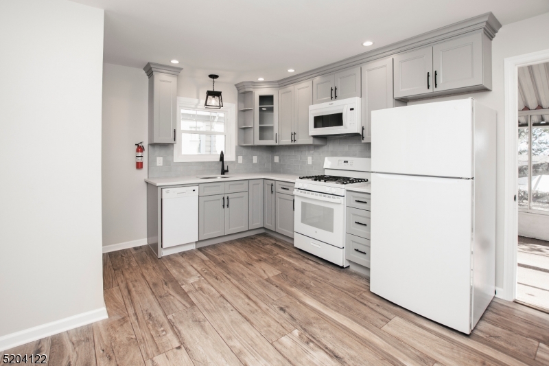 13 Clark Street Summit, NJ 07901 - Photo 9 of 24 a kitchen with white cabinets and white appliances