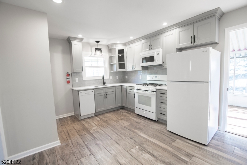 13 Clark Street Summit, NJ 07901 - Photo 10 of 24 a kitchen with white cabinets sink and white appliances