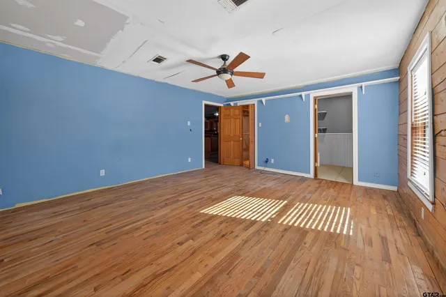 wooden floor in an empty room with a window
