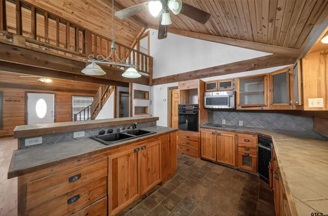 a kitchen with stainless steel appliances granite countertop a sink and cabinets
