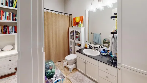 a bedroom with a bed and a book shelf