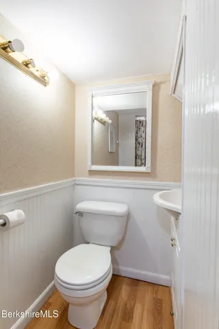 a bedroom with a bed a chandelier and a window