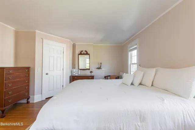 a view of a hallway with wooden floor and workspace
