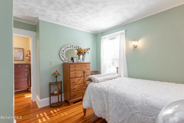 a bathroom with double vanity and a mirror