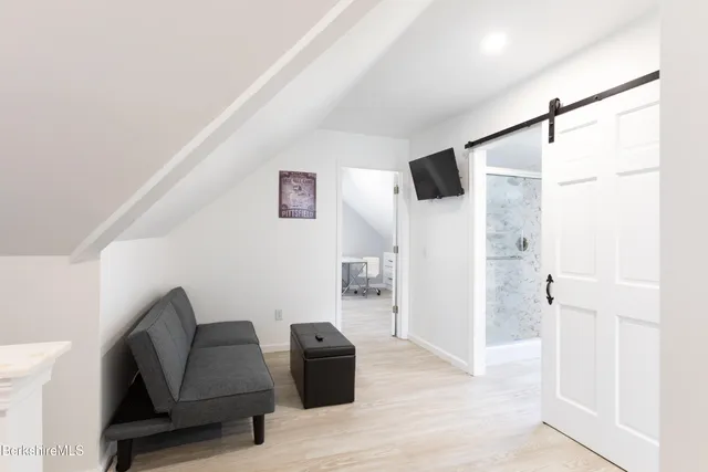 a bedroom with a bed and chair