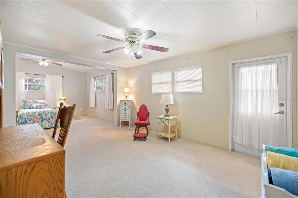 5791 Orange Blossom Road Venice, FL 34293 - Photo 13 of 55 a living room with furniture and a chandelier