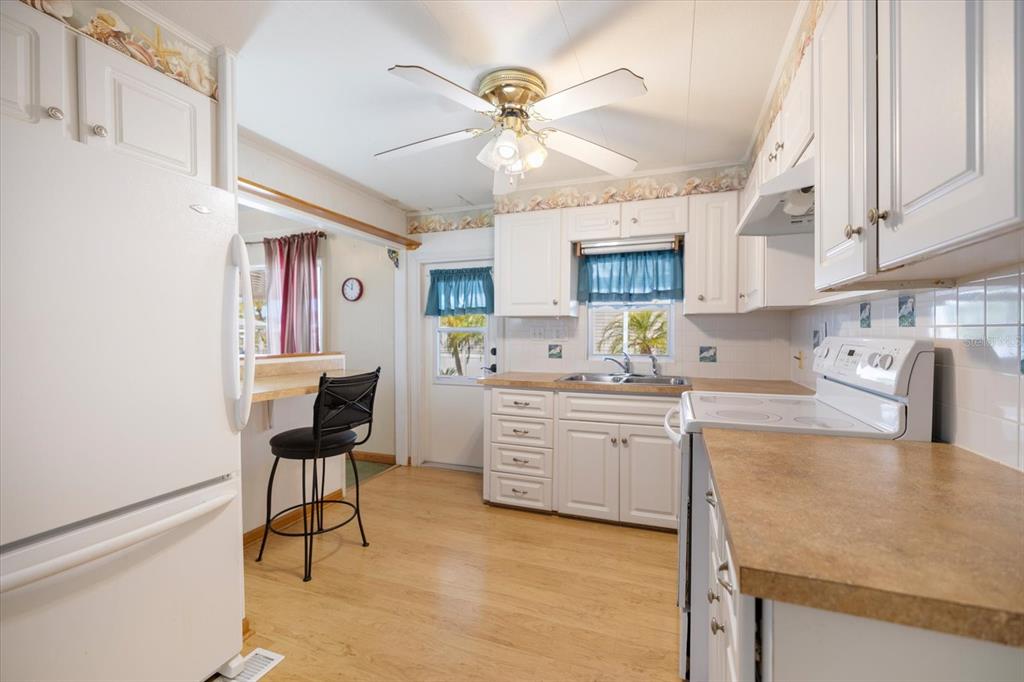 5791 Orange Blossom Road Venice, FL 34293 - Photo 2 of 55 a kitchen with granite countertop a sink appliances cabinets and furniture