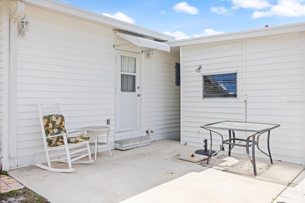 5791 Orange Blossom Road Venice, FL 34293 - Photo 38 of 55 a building outdoor space with a bench and chairs