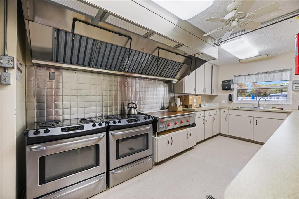 5791 Orange Blossom Road Venice, FL 34293 - Photo 51 of 55 a kitchen with stainless steel appliances granite countertop a stove and a sink