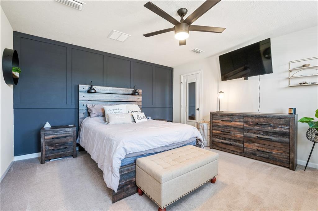 230 James Patrick Place Zelienople, PA 16063 - Photo 13 of 34 a bedroom with a bed a tv and wooden floor