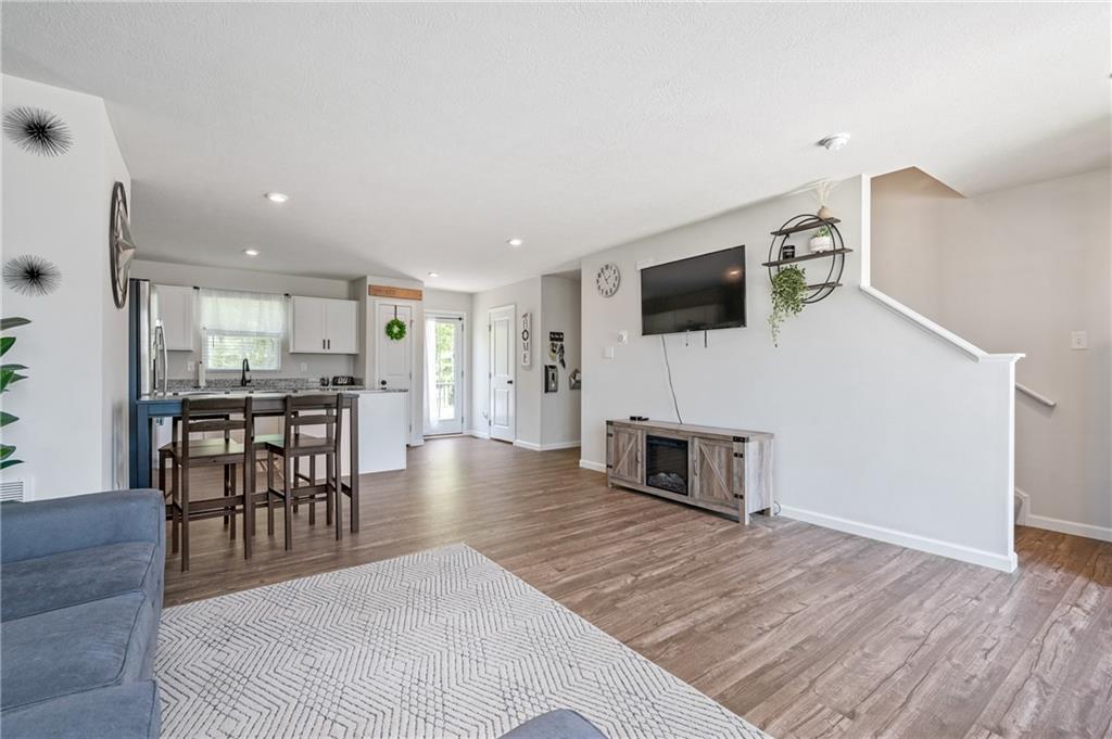 230 James Patrick Place Zelienople, PA 16063 - Photo 4 of 34 a living room with furniture a flat screen tv and a fireplace