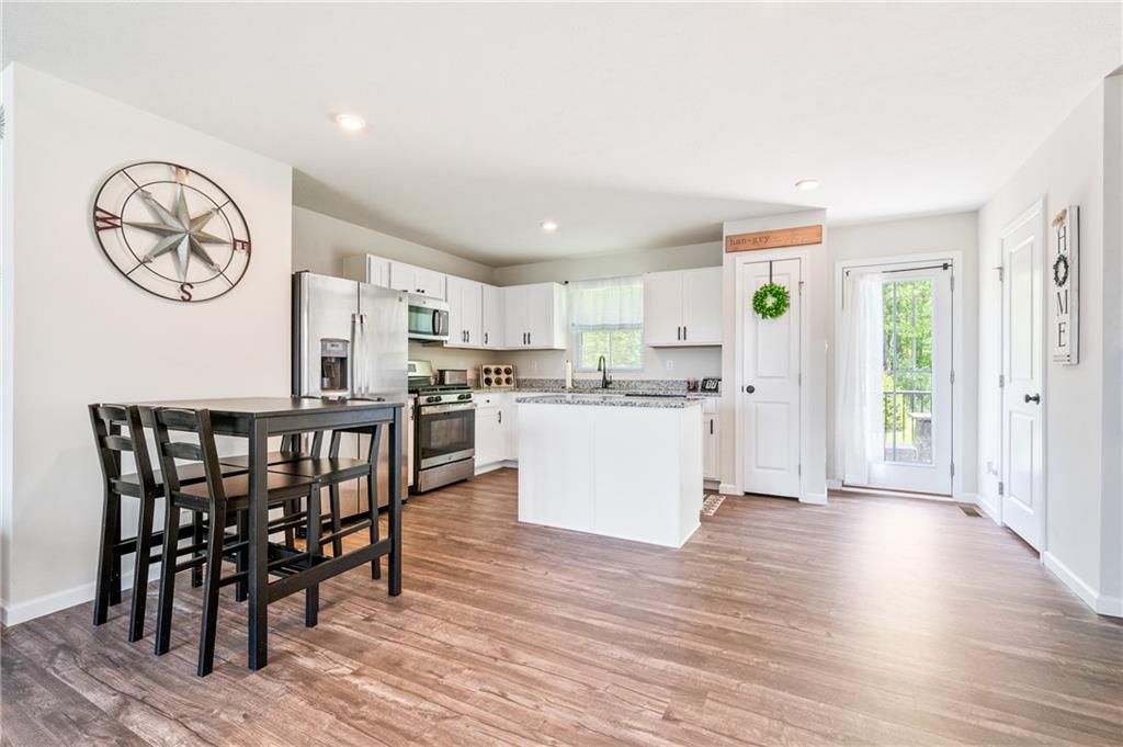 230 James Patrick Place Zelienople, PA 16063 - Photo 5 of 34 a kitchen with a table chairs a refrigerator a stove a dining table and chairs
