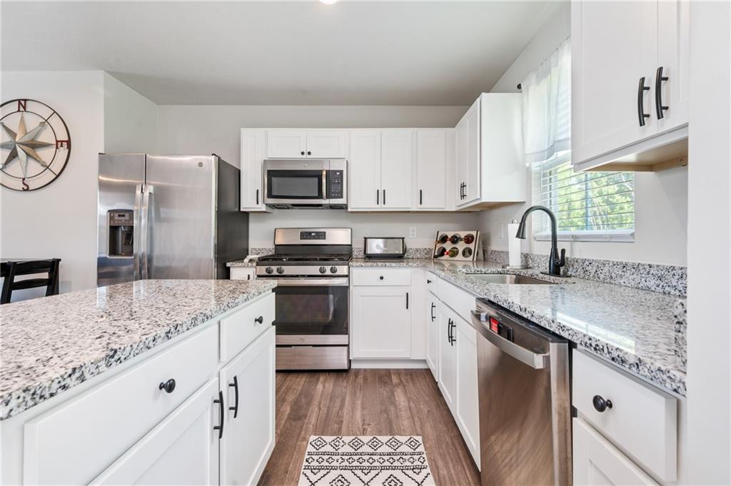 230 James Patrick Place Zelienople, PA 16063 - Photo 8 of 34 a kitchen with granite countertop a sink stove and refrigerator