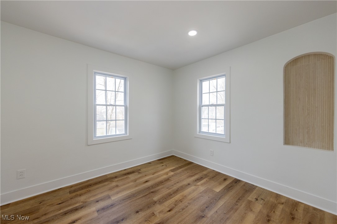 3694 Chelton Road Cleveland, OH 44120 - Photo 22 of 33 Unfurnished room featuring baseboards, arched walkways, light wood-style flooring, and recessed lighting