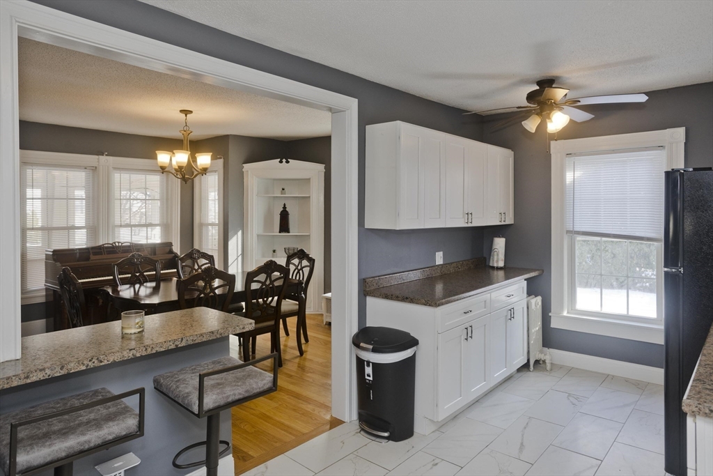 60 Mill Street Westfield, MA 01085 - Photo 11 of 42 a kitchen with granite countertop a stove a sink and a refrigerator