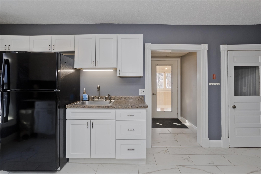 60 Mill Street Westfield, MA 01085 - Photo 12 of 42 a kitchen with a refrigerator and cabinets