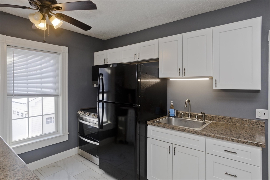 60 Mill Street Westfield, MA 01085 - Photo 13 of 42 a kitchen with a refrigerator and a sink