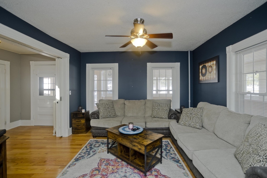 60 Mill Street Westfield, MA 01085 - Photo 20 of 42 a living room with furniture and a chandelier