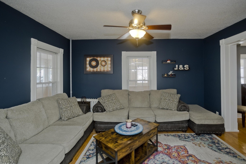 60 Mill Street Westfield, MA 01085 - Photo 22 of 42 a living room with furniture and a chandelier