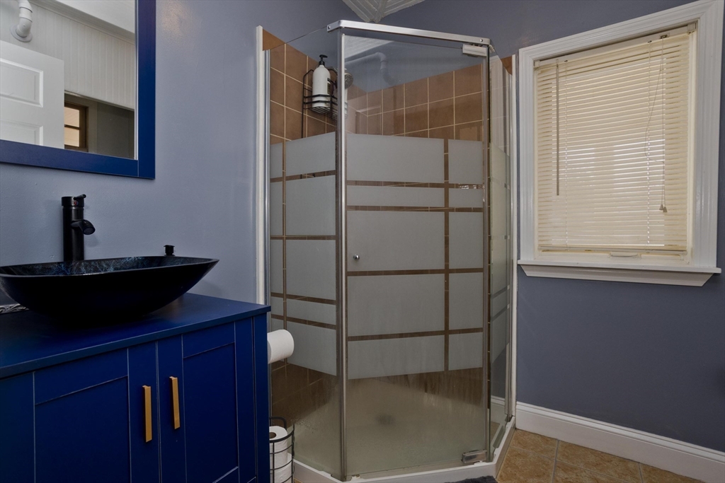 60 Mill Street Westfield, MA 01085 - Photo 26 of 42 a bathroom with a sink and a mirror