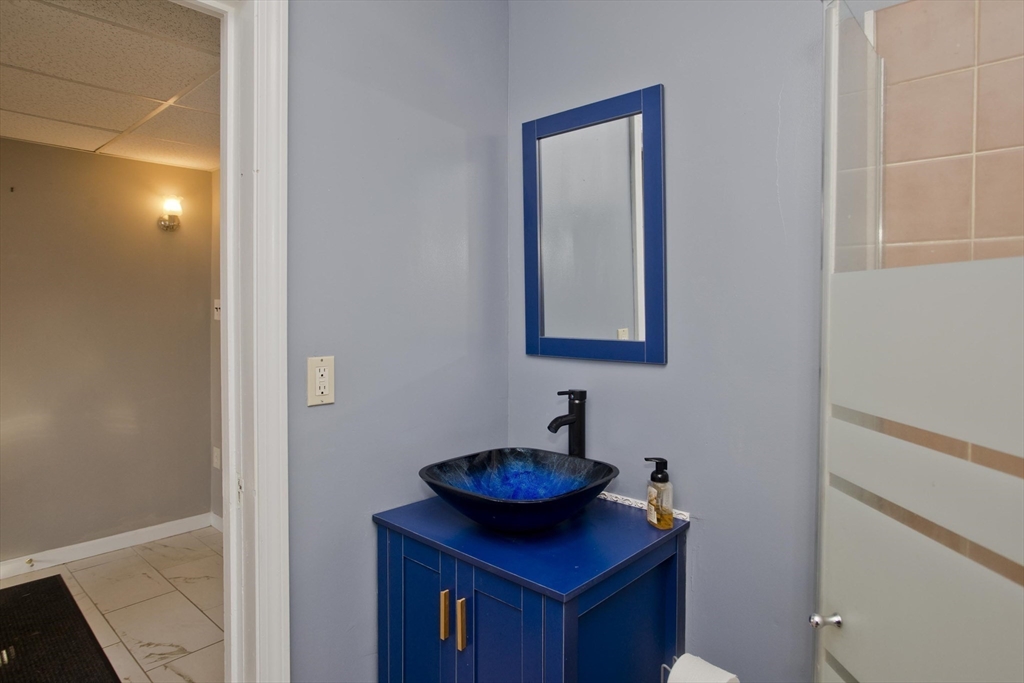 60 Mill Street Westfield, MA 01085 - Photo 27 of 42 a bathroom with a sink and a mirror