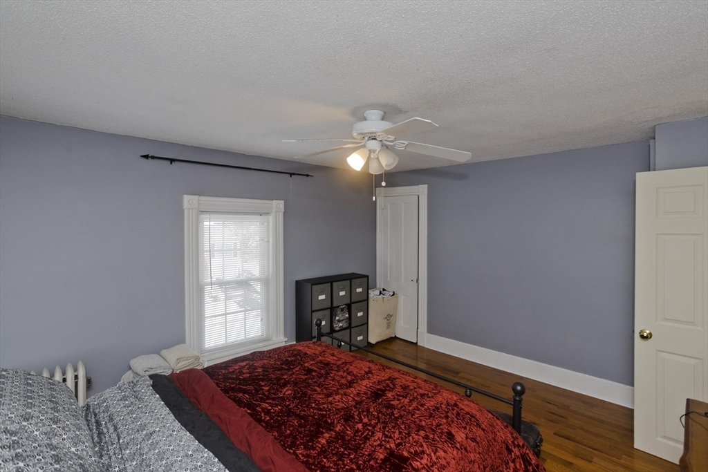 60 Mill Street Westfield, MA 01085 - Photo 30 of 42 a bedroom with a bed and a window with chair