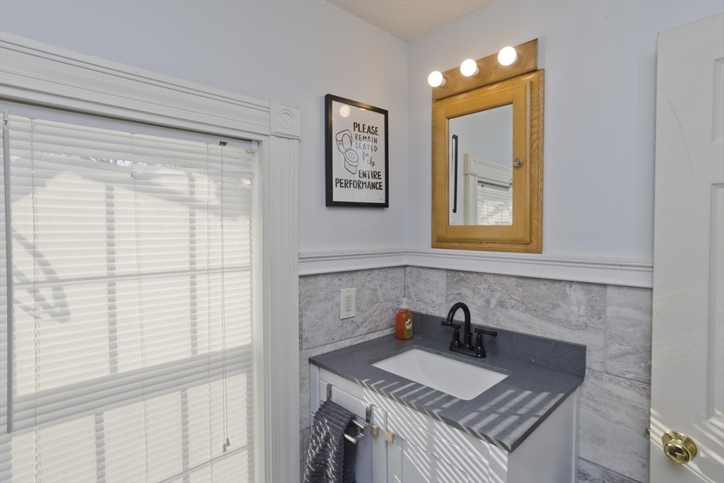 60 Mill Street Westfield, MA 01085 - Photo 35 of 42 a bathroom with a granite countertop sink and a window