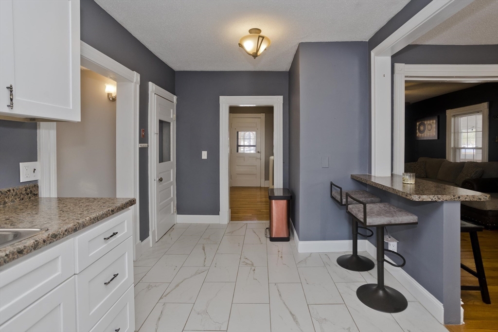 60 Mill Street Westfield, MA 01085 - Photo 10 of 42 a spacious bathroom with a granite countertop sink a mirror and shower