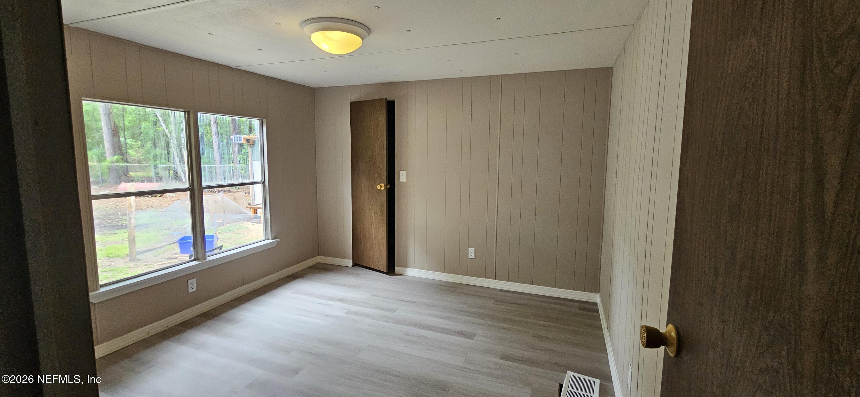 5363 Kilcrease Road Jacksonville, FL 32234 - Photo 13 of 29 a view of an empty room with wooden floor and a window