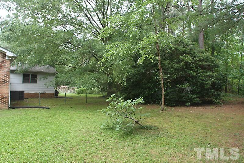 4616 Waterbury Road Raleigh, NC 27604 - Photo 12 of 12 a view of a garden with a bench