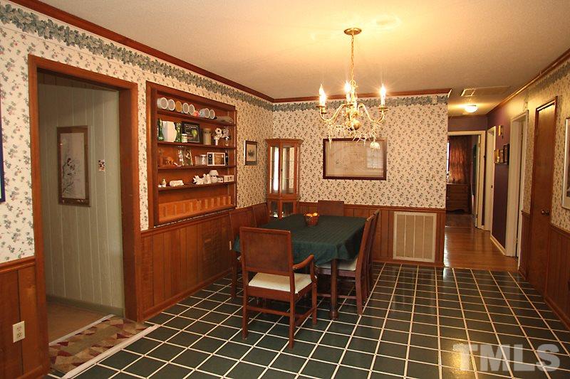 4616 Waterbury Road Raleigh, NC 27604 - Photo 5 of 12 a view of a dining room with furniture and chandelier