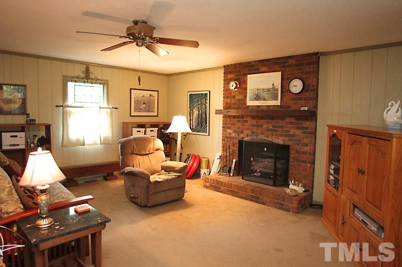 4616 Waterbury Road Raleigh, NC 27604 - Photo 6 of 12 a living room with furniture and a fireplace