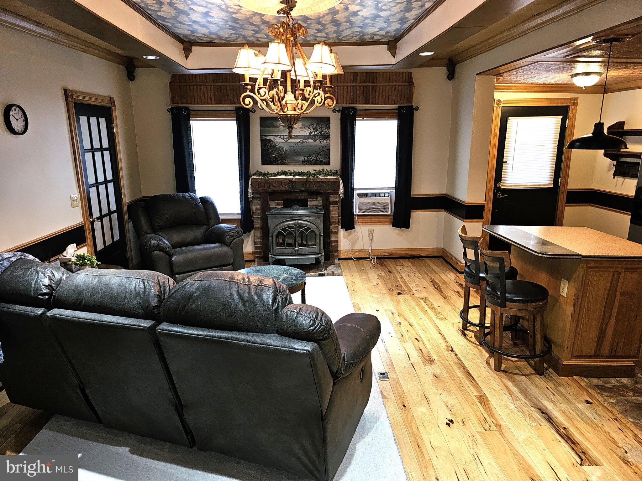 75 King Street Milroy, PA 17063 - Photo 11 of 19 a living room with furniture a chandelier and a flat screen tv