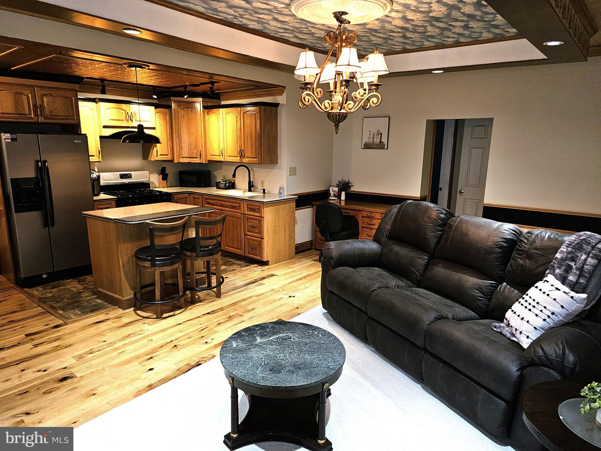 75 King Street Milroy, PA 17063 - Photo 12 of 19 a living room with furniture a chandelier and a dining table