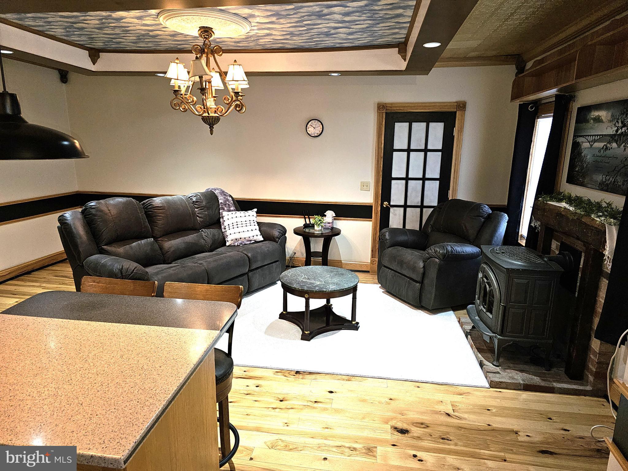 75 King Street Milroy, PA 17063 - Photo 10 of 19 a living room with furniture and a chandelier