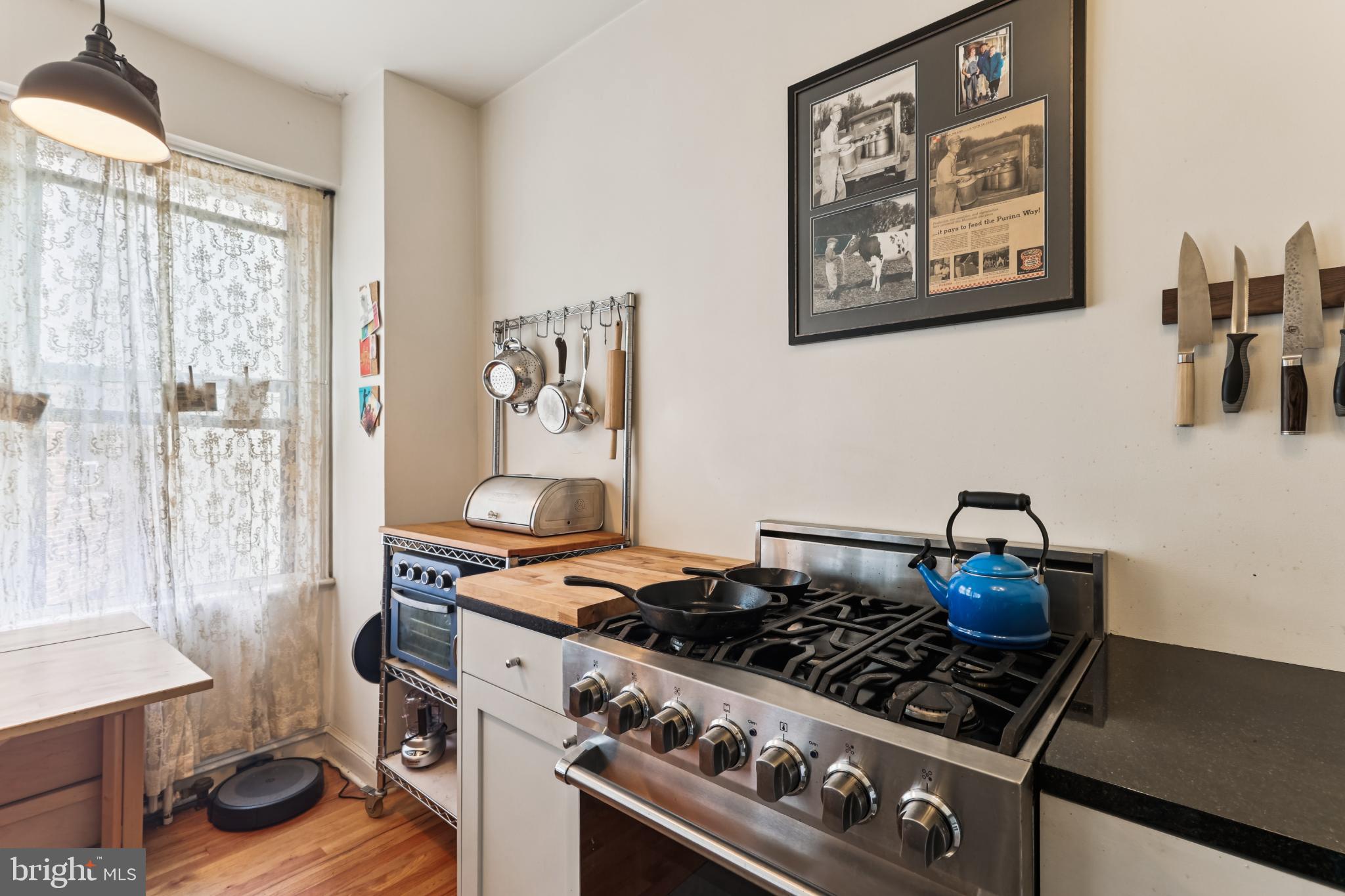 1365 Kennedy Street Northwest, Unit 209 Washington, DC 20011 - Photo 14 of 35 a kitchen with stove and cabinets