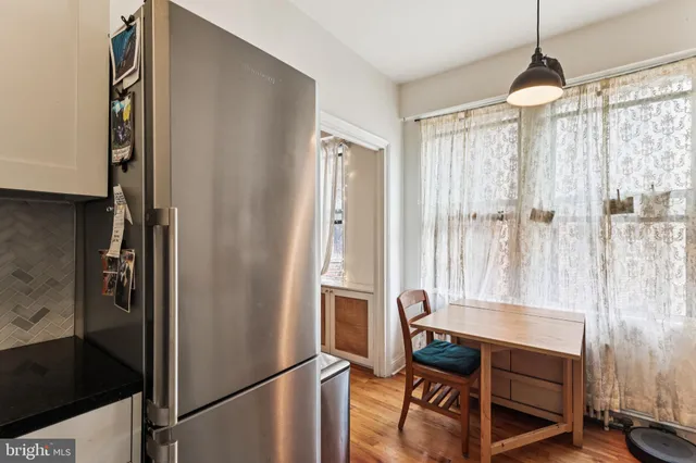 a dining room with furniture and a window