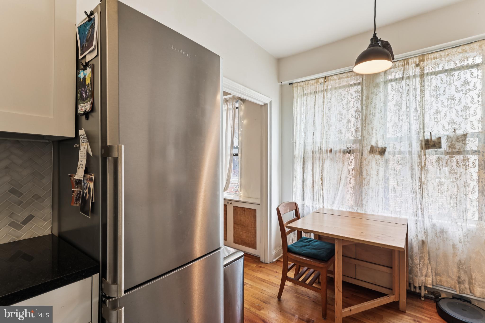 1365 Kennedy Street Northwest, Unit 209 Washington, DC 20011 - Photo 17 of 35 a dining room with furniture and a window