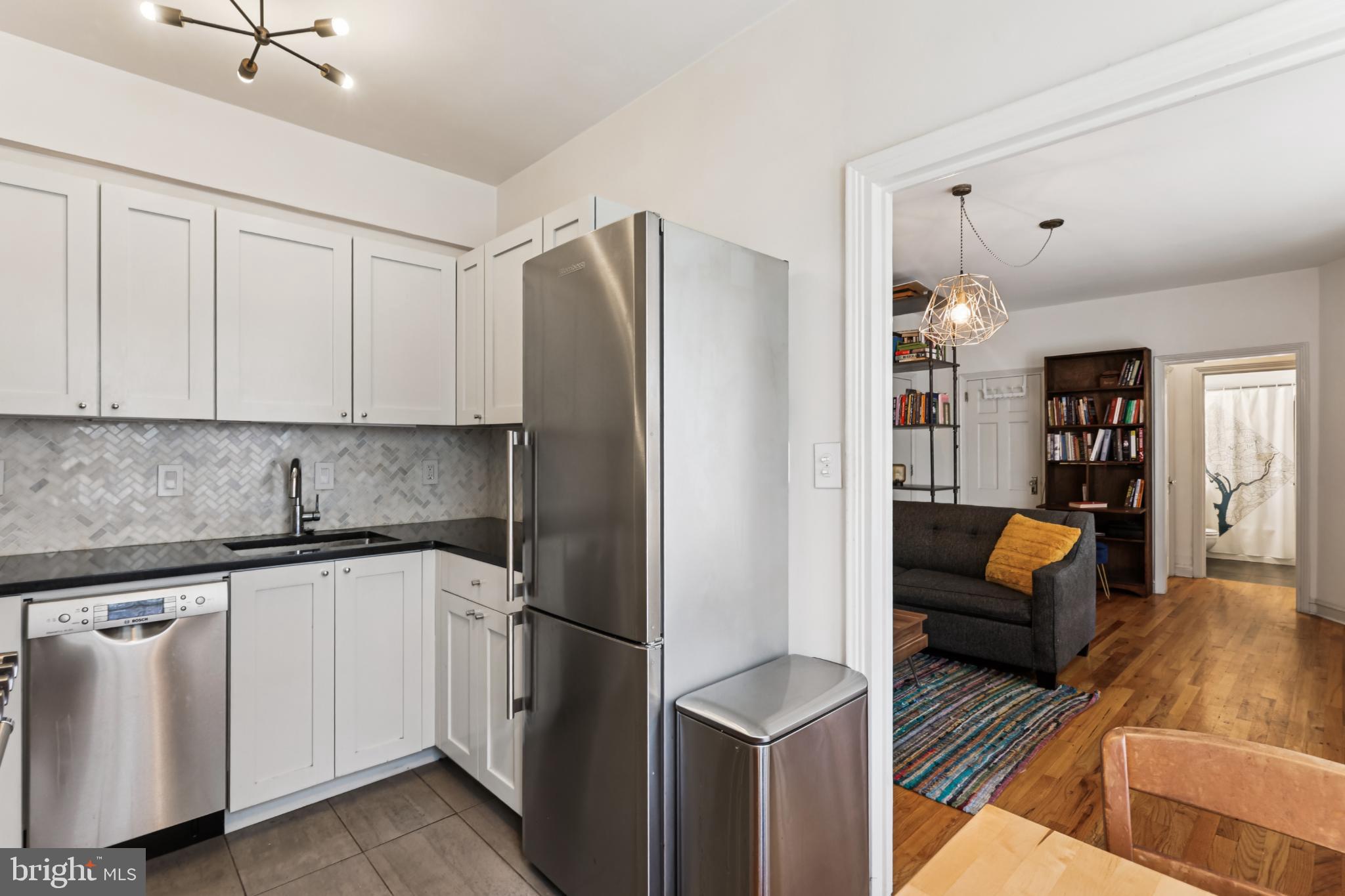 1365 Kennedy Street Northwest, Unit 209 Washington, DC 20011 - Photo 18 of 35 a kitchen with stainless steel appliances granite countertop a refrigerator and a sink