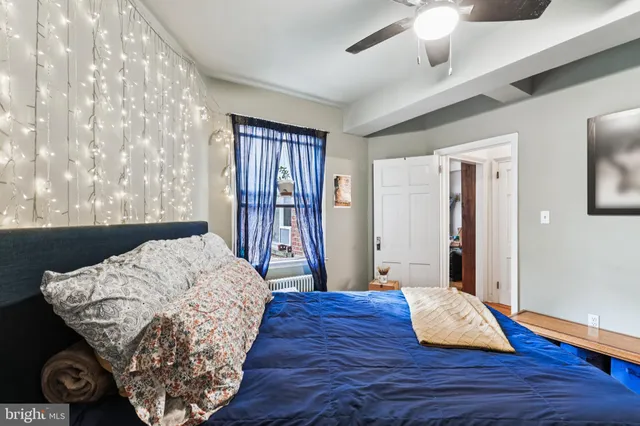 a living room with a bed furniture and a window