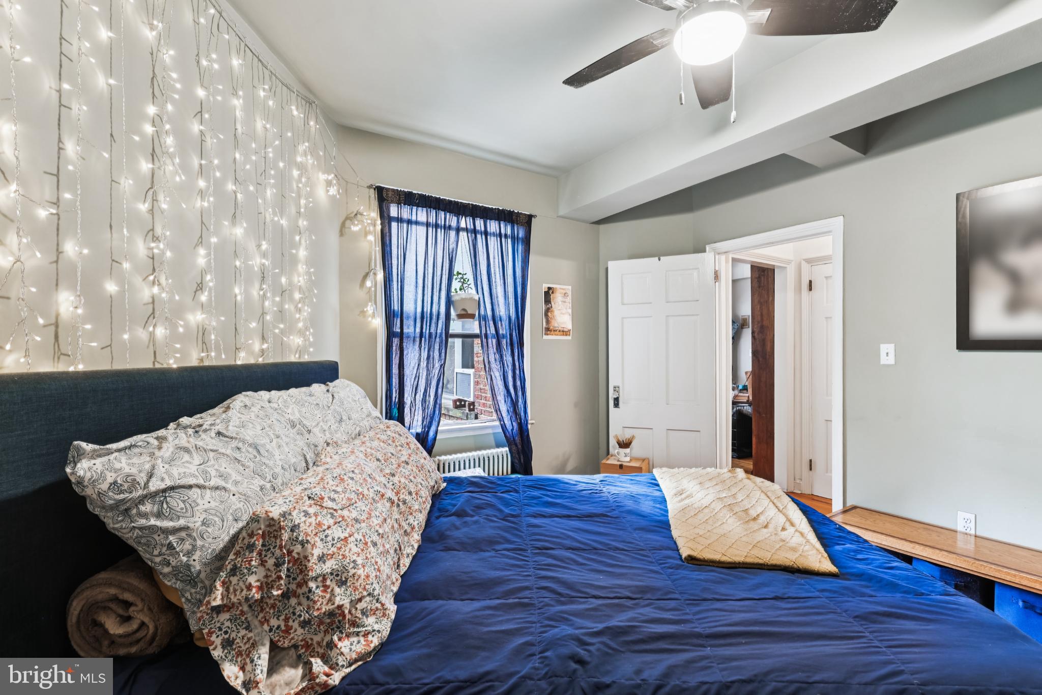 1365 Kennedy Street Northwest, Unit 209 Washington, DC 20011 - Photo 22 of 35 a living room with a bed furniture and a window