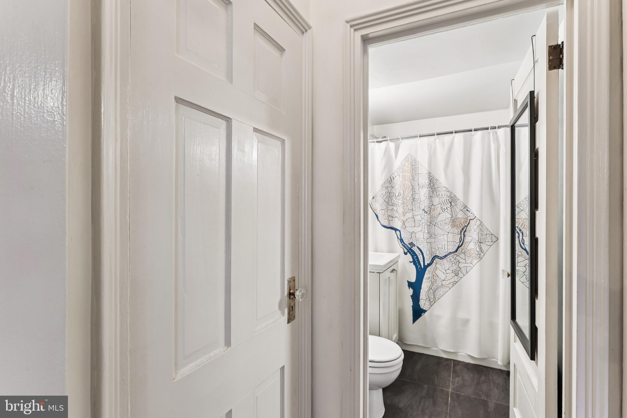 1365 Kennedy Street Northwest, Unit 209 Washington, DC 20011 - Photo 23 of 35 a bathroom with a granite countertop sink and a toilet