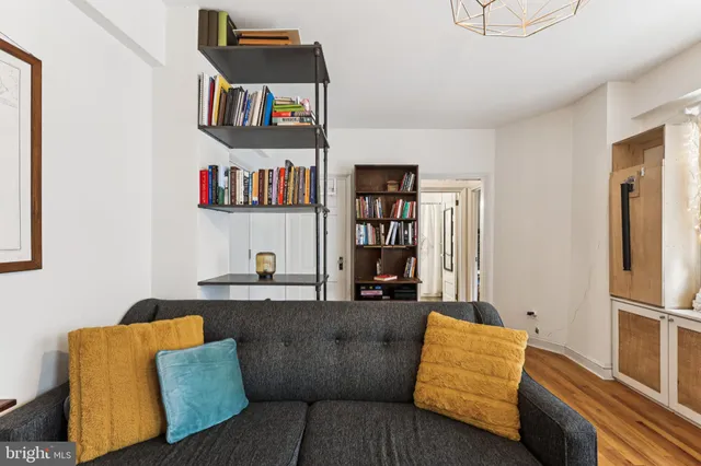 a living room with furniture and a book shelf