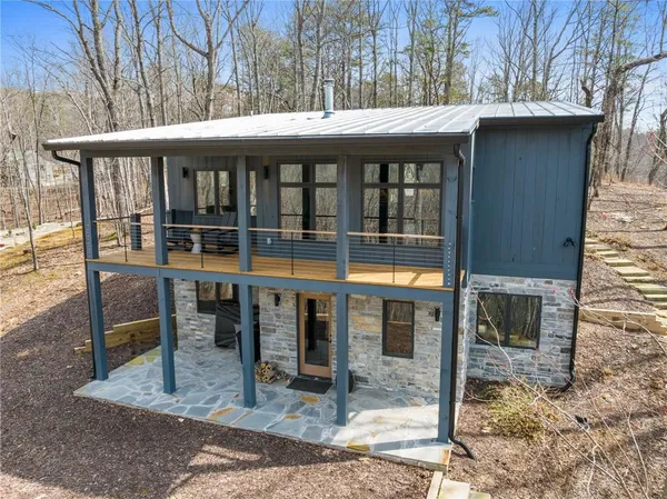 a view of a house with backyard porch and sitting area