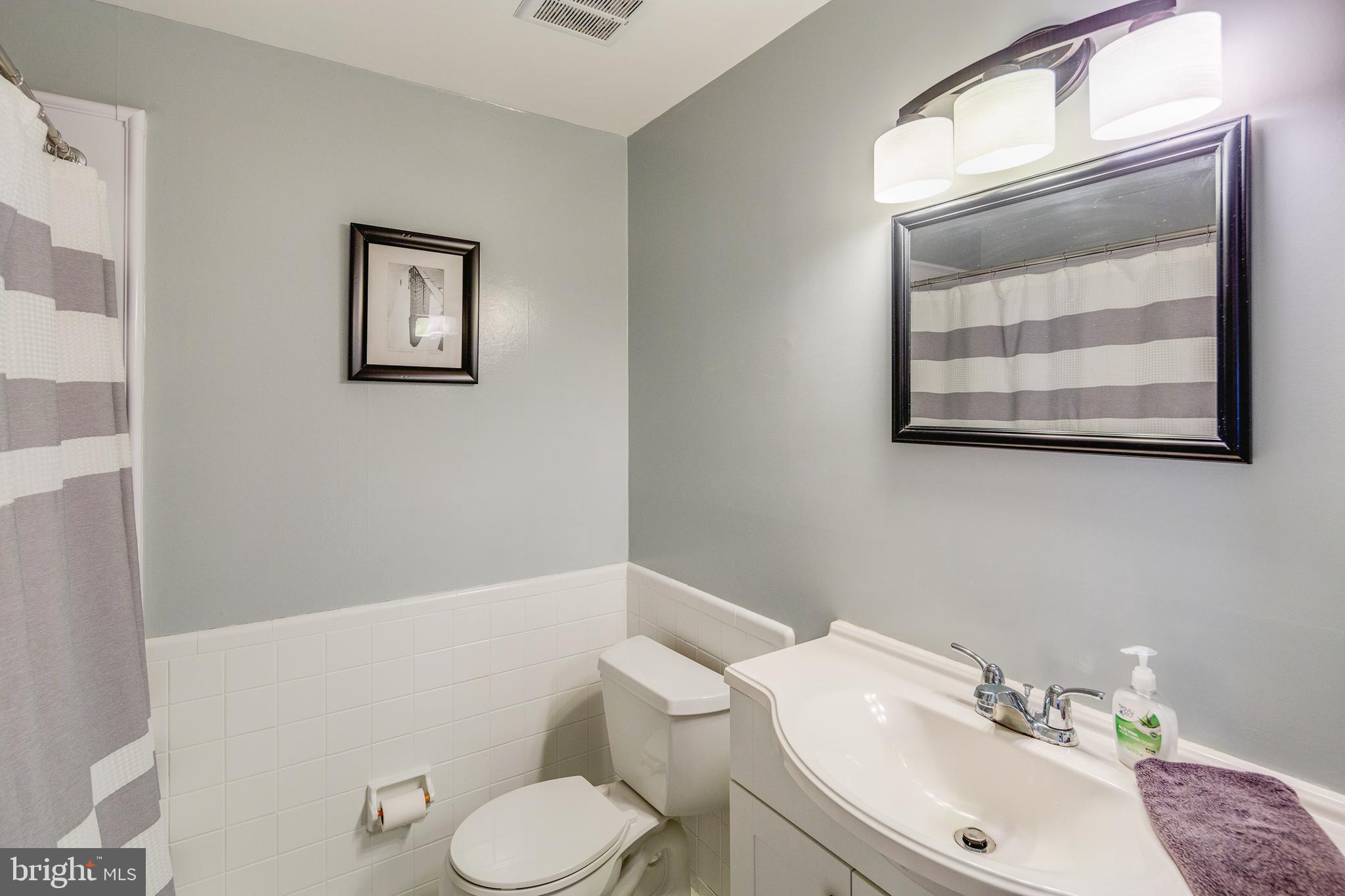 110 Courtland Road Cherry Hill, NJ 08034 - Photo 11 of 28 a bathroom with a toilet sink and mirror
