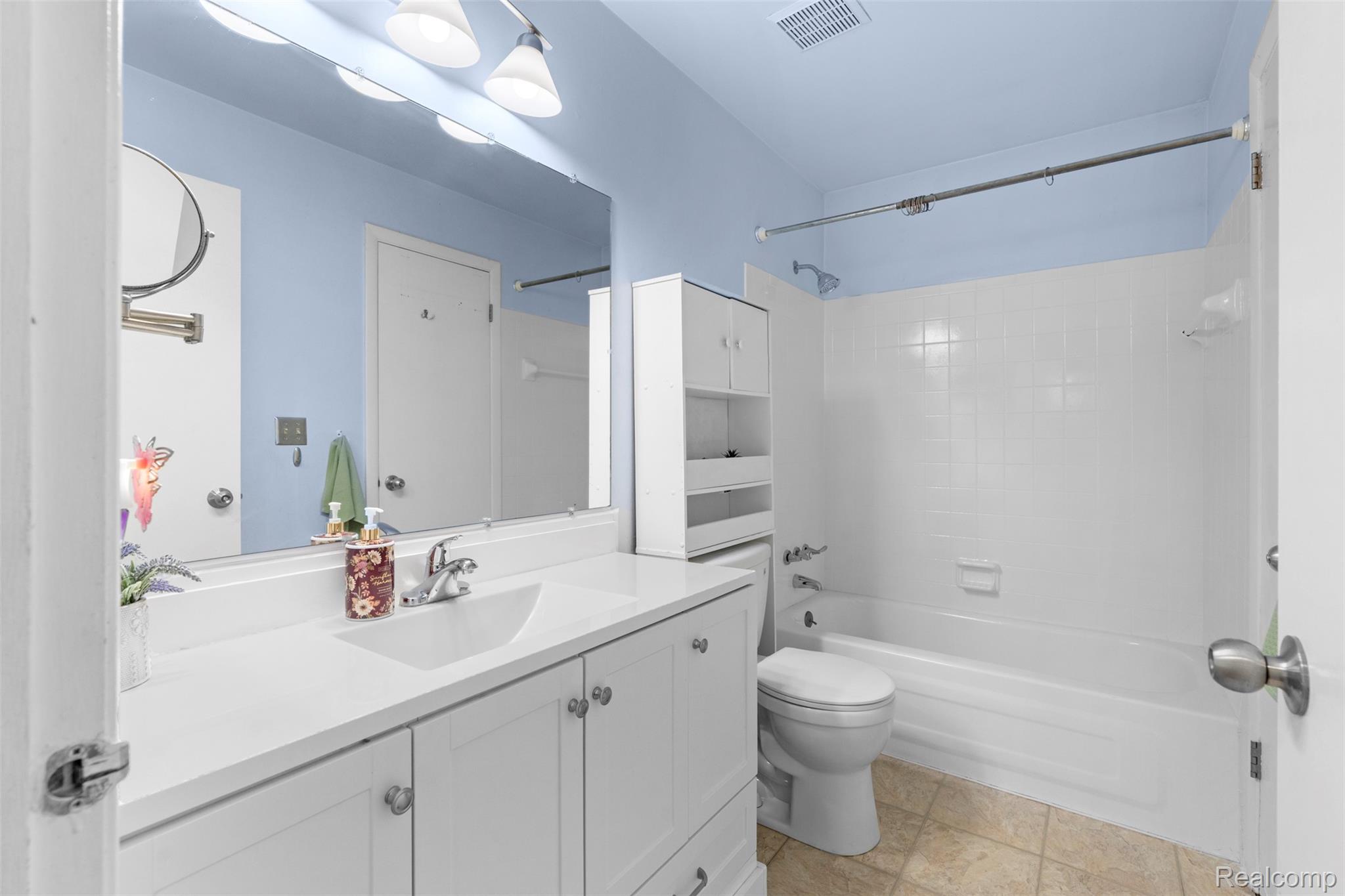 22530 Sheridan Road Novi, MI 48375 - Photo 15 of 50 Bathroom with bathing tub / shower combination, vanity, and light tile patterned floors