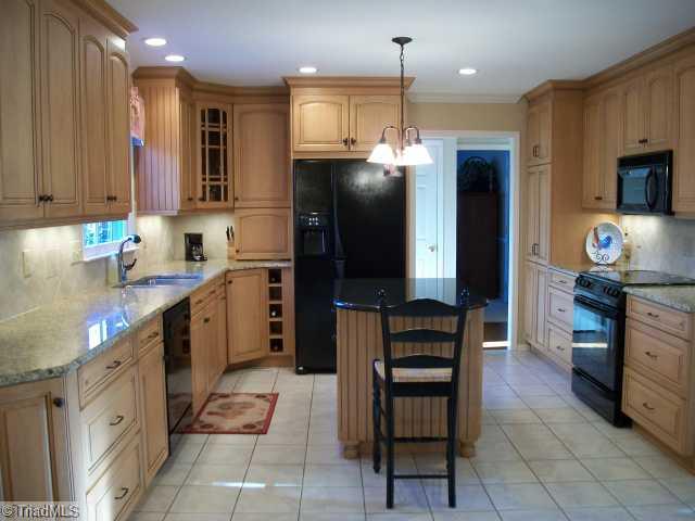 1640 Slane Road Clemmons, NC 27012 - Photo 3 of 16 Kitchen. The kitchen features tile floors, tile backsplash, granite countertops, and a island.